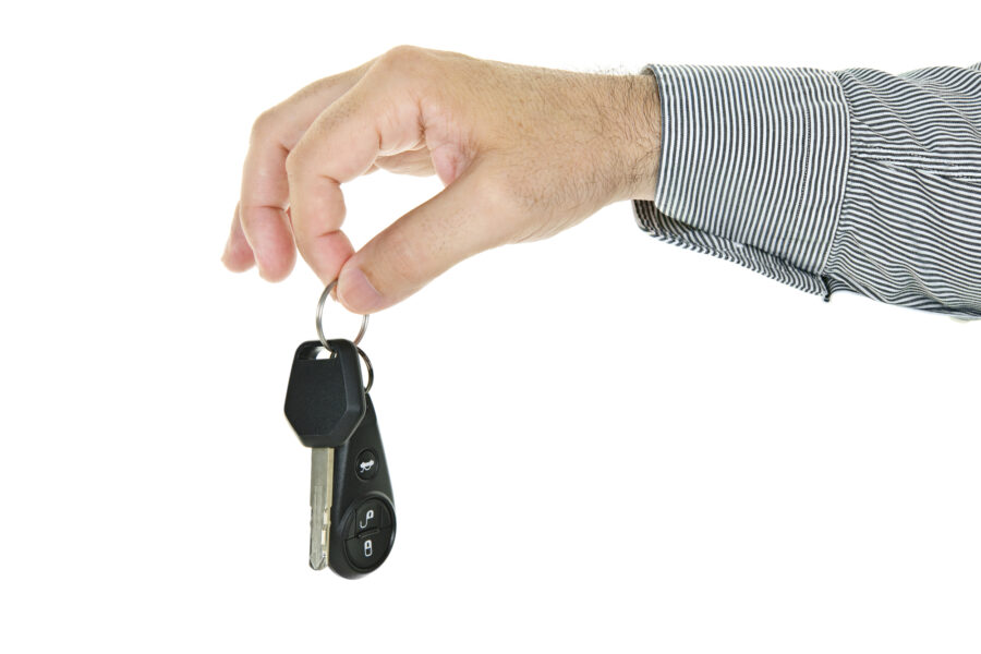 Hand holding car key